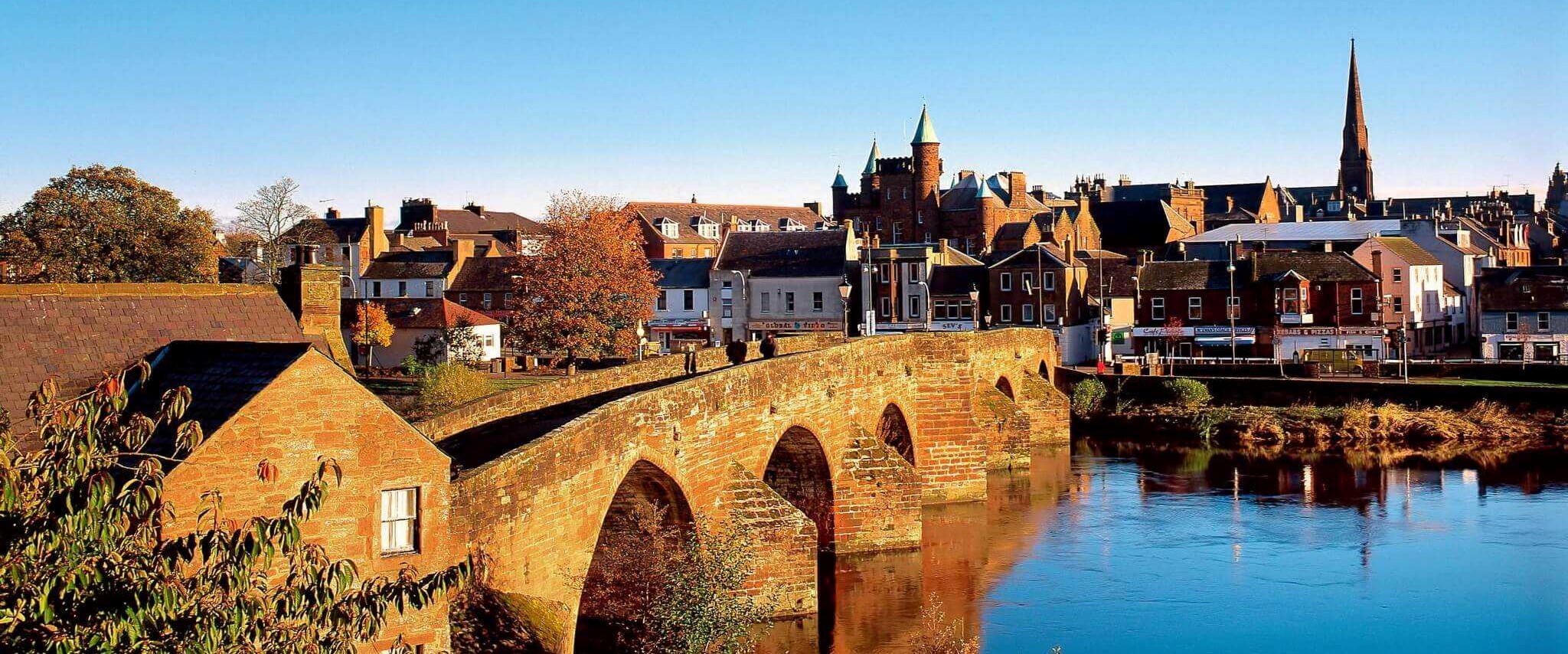 Looking Across The River Nith To The Devorgilla Bridge In The Town Of Dumfries