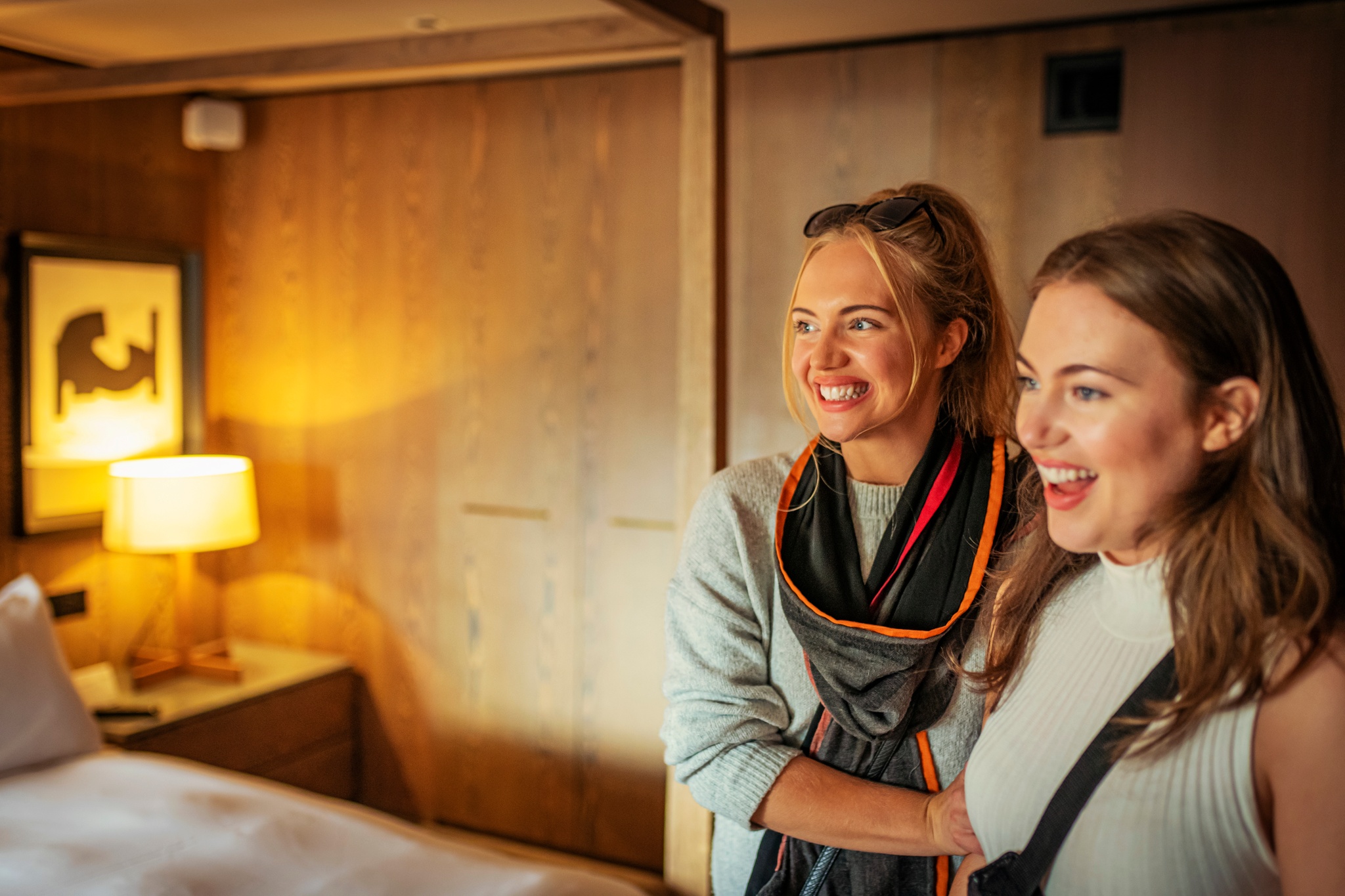 Two guests admire their room at Kimpton Blythswood Square Hotel