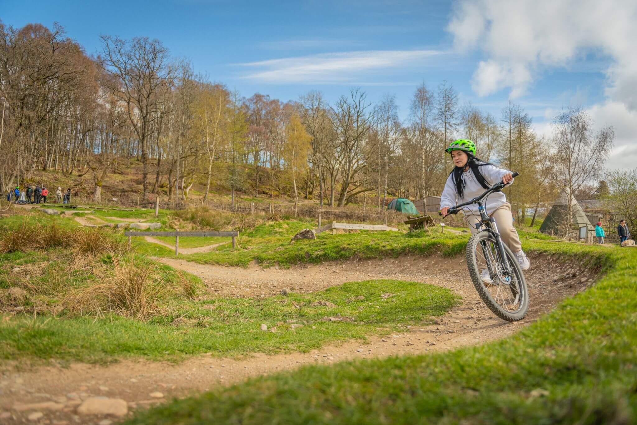 A woman riding her bike at Comrie Croft Skills and Fun Park.