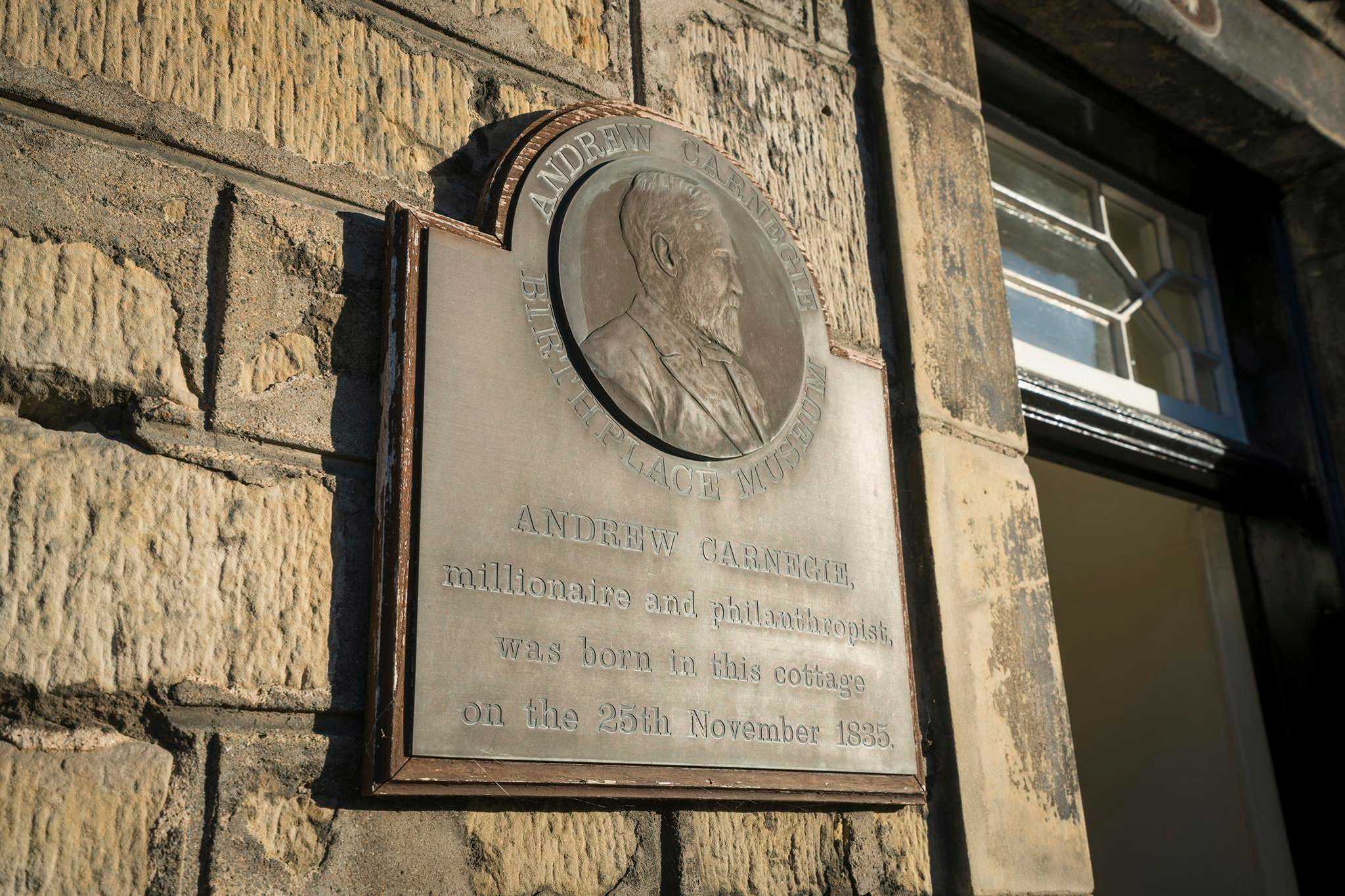 A bronze wall plaque marking birthplace of Andrew Carnegie