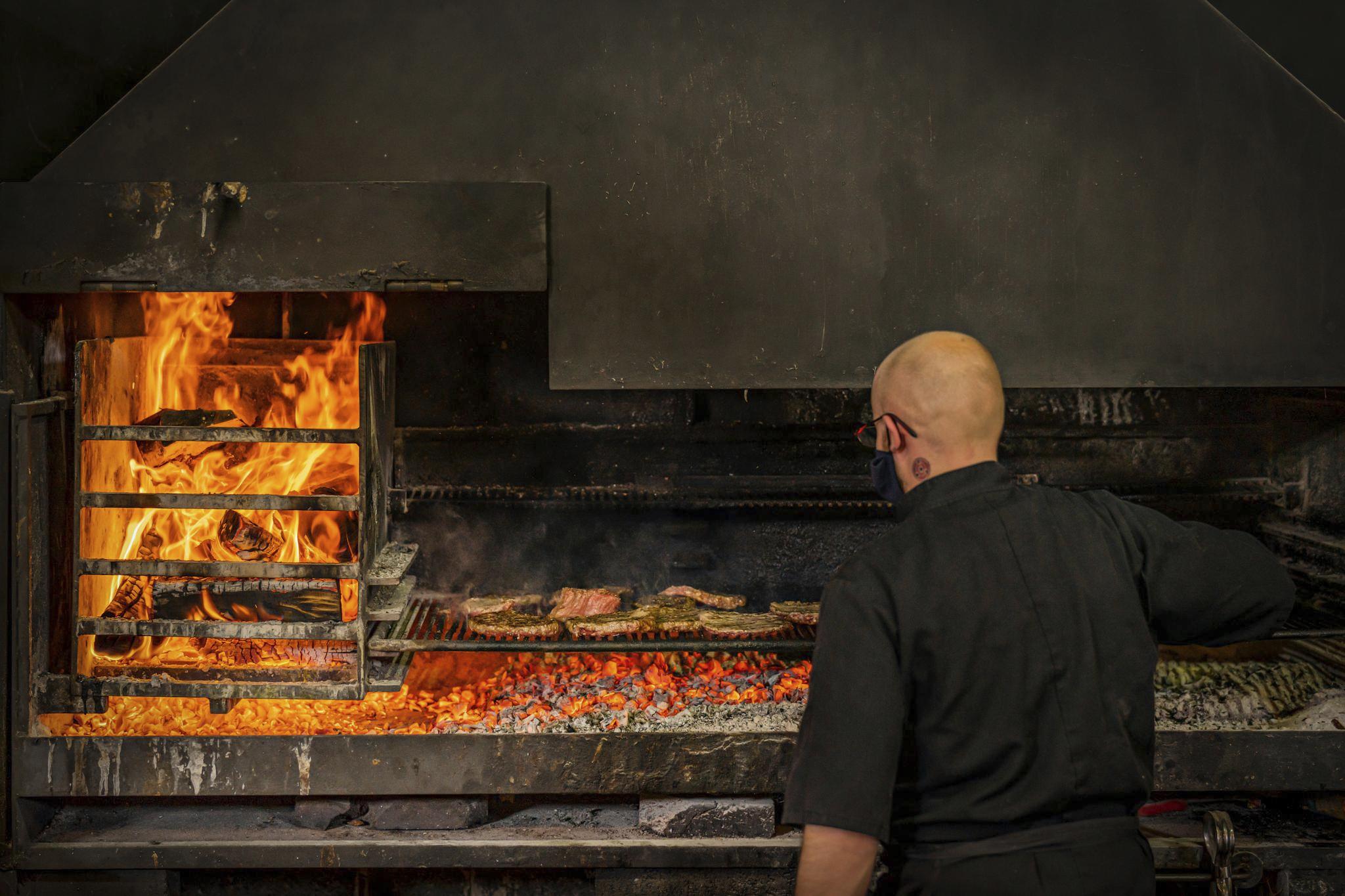 Meat cooking on open flames at Balgove Larder