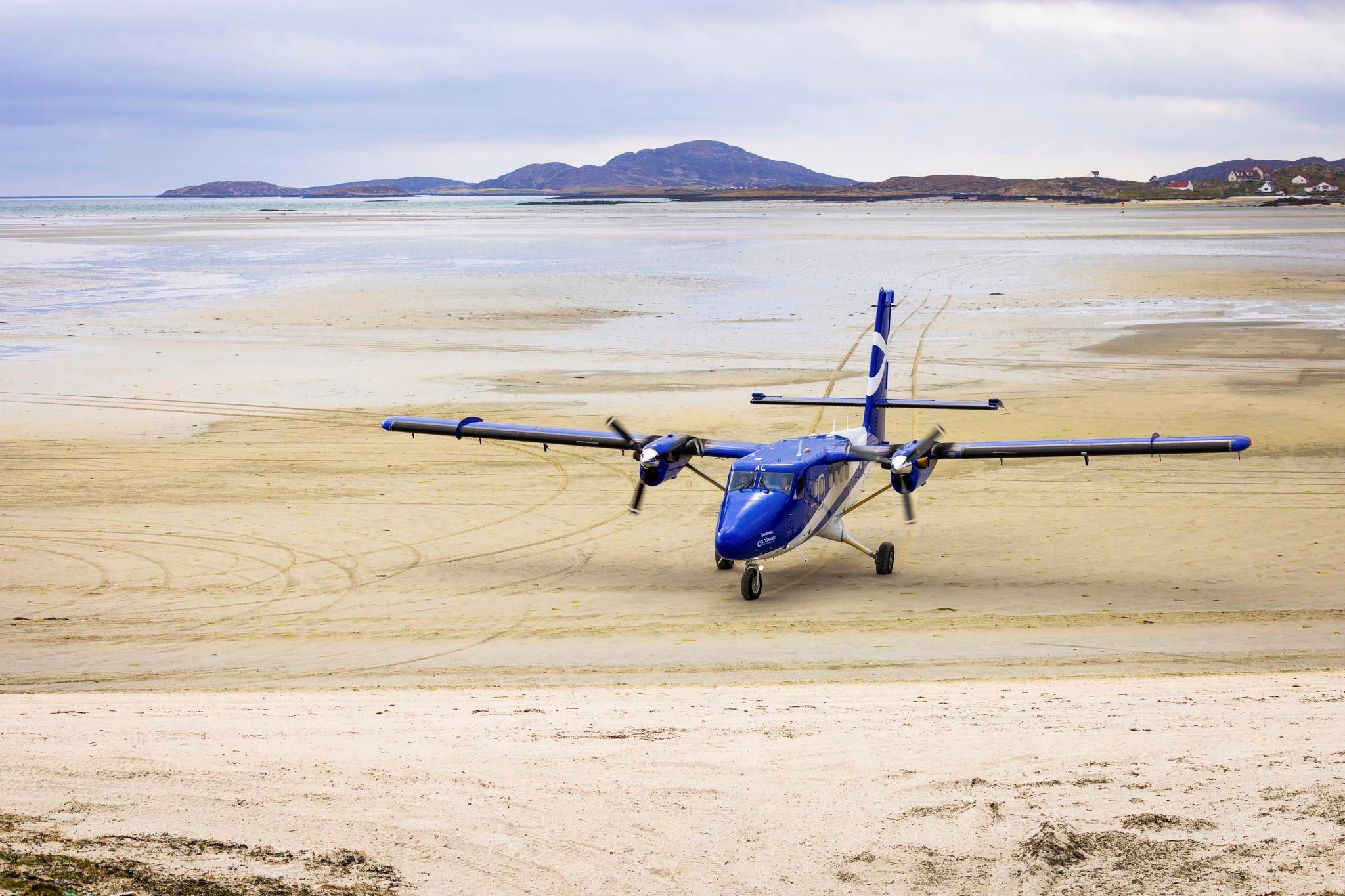 A small plane sits on a the sandy beach of Barra