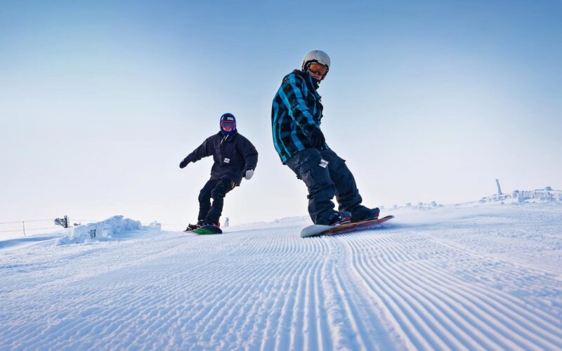 Two Snowboarders Enjoying The Lecht Pistes