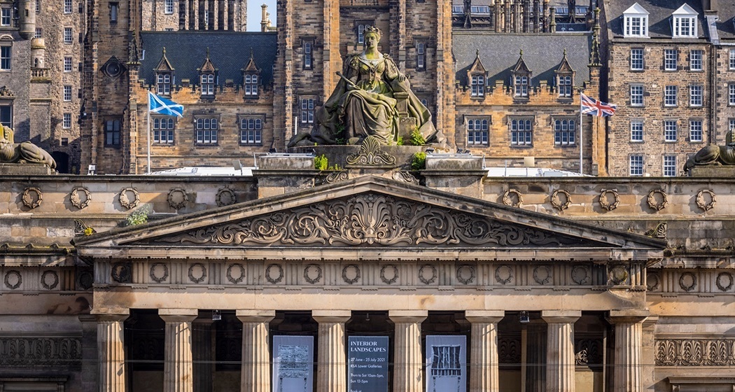 Die Spitze der Royal Scottish Academy mit zahlreichen Gebäuden der Altstadt im Hintergrund.