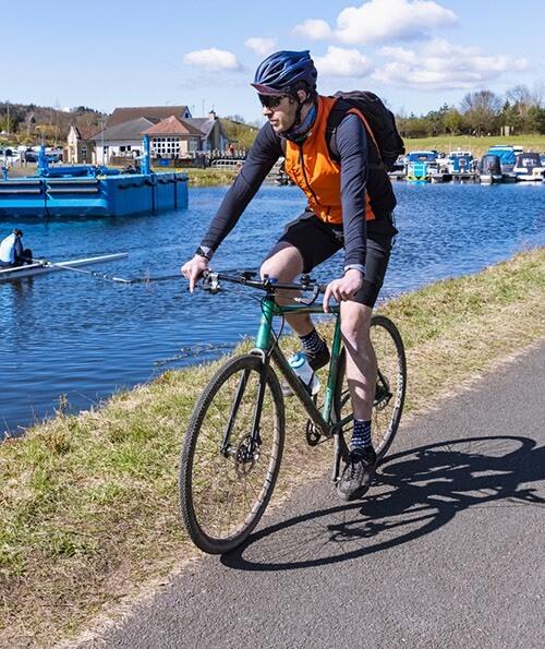 A cyclist on the towpath of the Forth and Clyde Canal at Auchinstarry Marina
