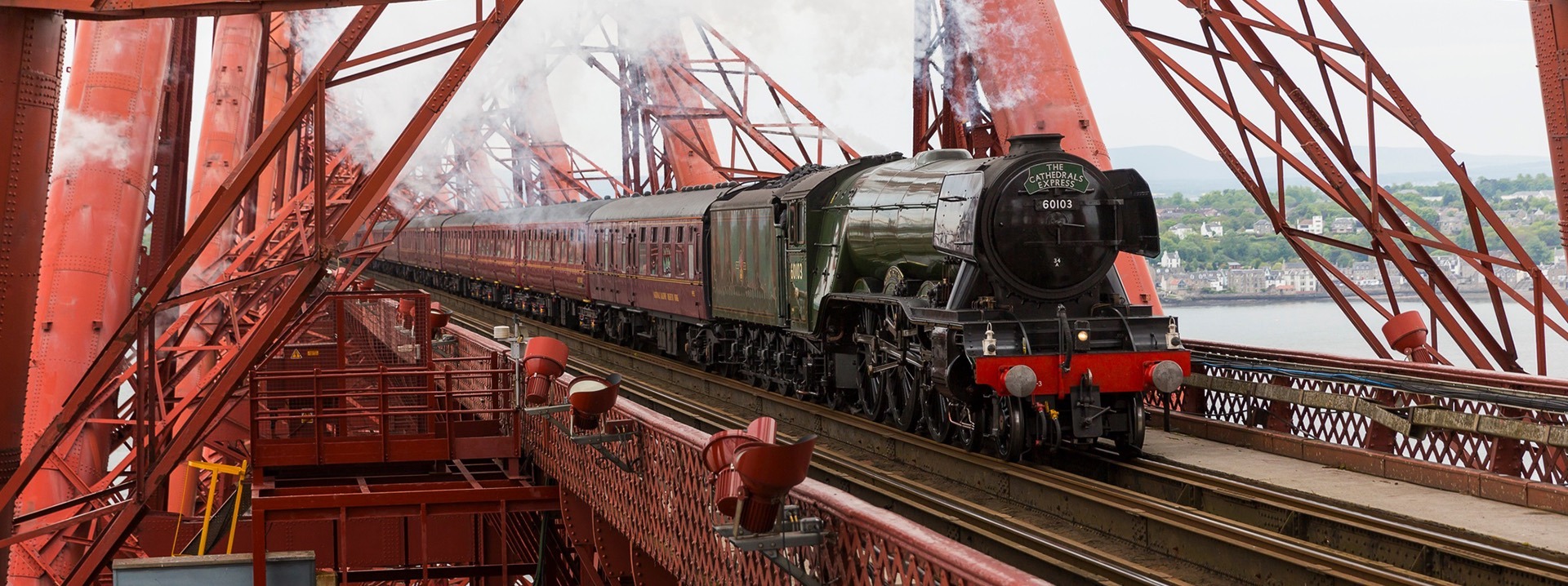 A close up of the Flying Scotsman train going along the Forth Bridge